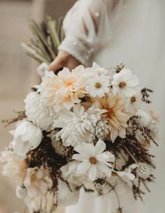 a person holding a bouquet of flowers in their hand