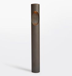 a tall metal tube with a round hole in the middle on a white background,