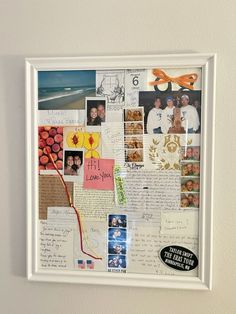 a collage of photos and letters is displayed on a white framed wall with scissors