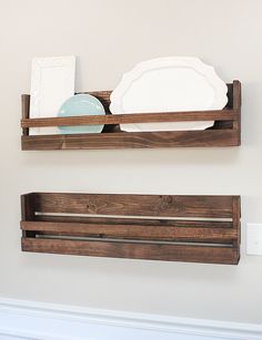 two wooden shelves with plates and napkins on them