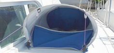 the inside of a boat with a blue seat and rope hanging from it's side