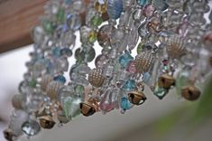 a bunch of glass beads hanging from a ceiling