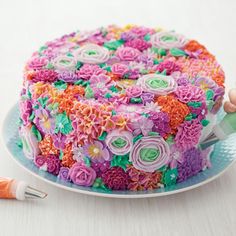 there is a cake decorated with flowers and icing on the plate next to it