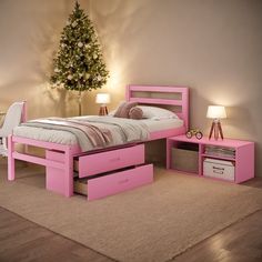 a bedroom with pink furniture and a christmas tree