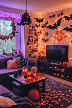 a living room decorated for halloween with bats and pumpkins