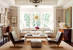 a living room filled with furniture and a chandelier