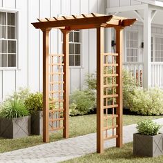 an outdoor wooden arbor in front of a white house with potted plants on the lawn