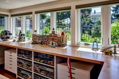 a kitchen with lots of windows and toys on the counter