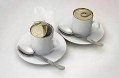 two coffee cups with spoons and saucers on them