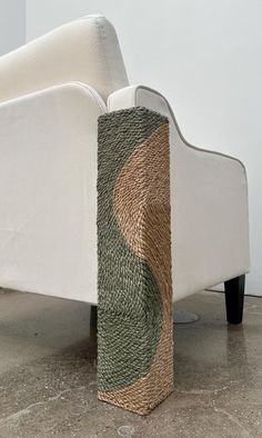 an upholstered couch with woven material on the back