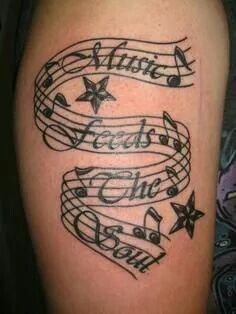 a tattoo with music notes and stars on it