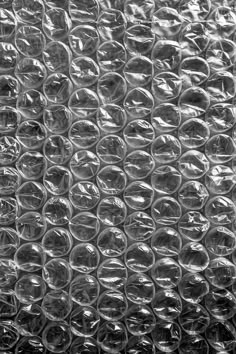 a close up view of some plastic bottle caps on a surface that is covered in bubble wrap