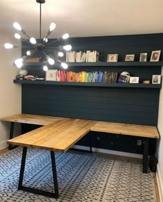 a wooden table sitting in front of a bookshelf