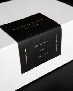 a black and white box with gold lettering on it