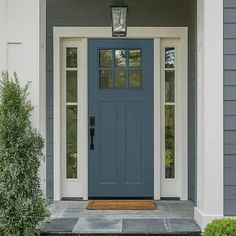 a blue front door on a gray house