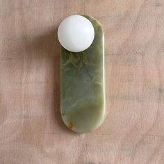 a green object with a white ball on it