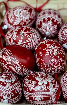 red and white decorated eggs in a basket