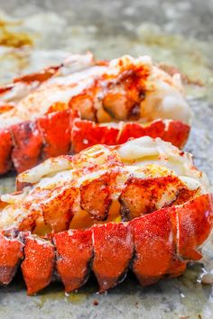 two lobsters are sitting on the counter ready to be cooked in the oven,