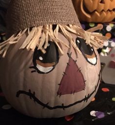 a decorated pumpkin sitting on top of a table