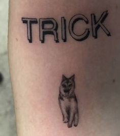 a tattoo that says trick with a cat on it