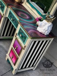 an ornate vanity with colorful drawers and mirror