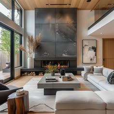 a living room with couches, chairs and a fire place in the middle of it