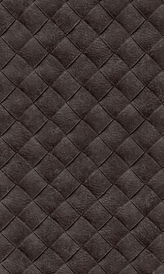 an up close shot of the texture of a dark brown leather material with diamond pattern