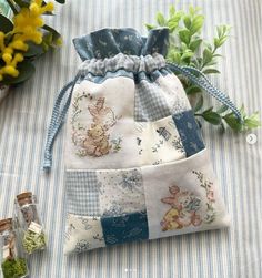 a small bag sitting on top of a table next to flowers