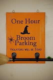 a broom is hanging on the wall next to a sign that says, one hour broom parking voltators will be toad