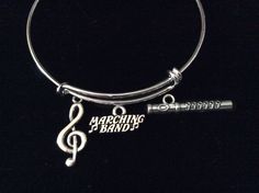 a silver bracelet with music notes on it and the words marching, i love you