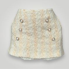 Pretty Crme Colored Tweed Mini Skirt With Gold Toned, Faux Pearl Buttons Such A Precious Piece! Retail Price Of 325$ Measurements: Waist: 30" Hip: 39" Length: 14.25" Fabric Composition: 73% Wool, 15% Polyester, 12% Acrylic Tweed Mini Skirt, Creme Color, Pearl Buttons, Faux Pearl, Mini Skirt, Womens Skirt, Mini Skirts, Composition, Size 10