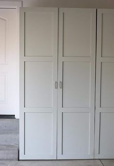 an empty room with white closets and stairs