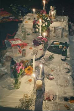 a table with candles and flowers on it