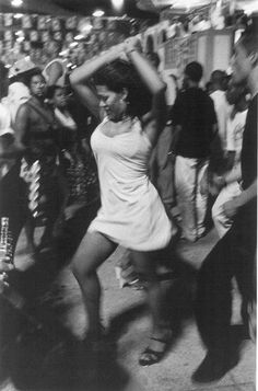 black and white photograph of people dancing in the street