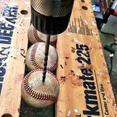 some baseballs and a bat on a table