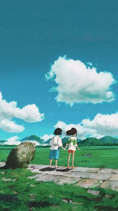 two people are standing on a rock looking at the sky with clouds in the background