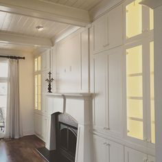 an empty living room with white walls and wood floors