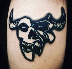 a man's head with horns and skulls on his face is shown in black ink