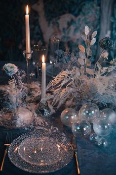 a table with candles, flowers and ornaments on it