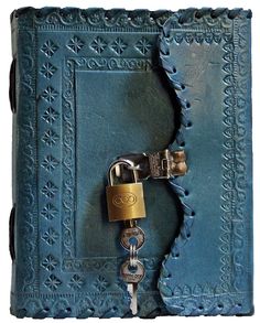 an old book with a lock and key attached to the cover is shown in this close up photo