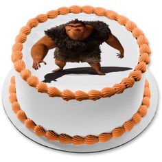 a cake with an image of a bigfoot on it's frosting and orange icing