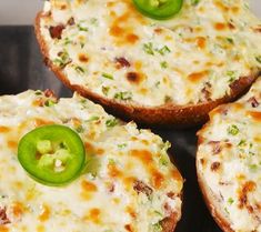 four pieces of bread with cheese and green peppers