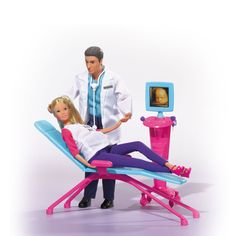 a barbie doll sitting in a chair next to a doctor