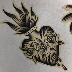 an old school tattoo design with flowers and a bird on it's back side