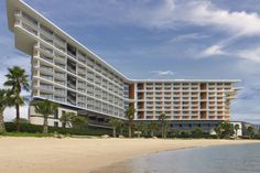 a hotel on the beach with palm trees