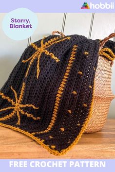 a crocheted bag sitting on top of a wooden table next to a basket