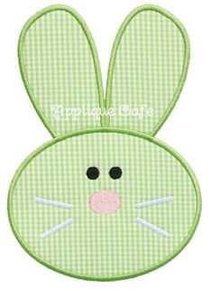 a green bunny face with black eyes and ears on it's head, embroidered onto a