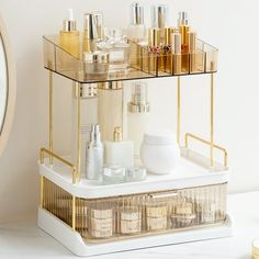 an assortment of beauty products displayed on a gold and white shelf next to a clock