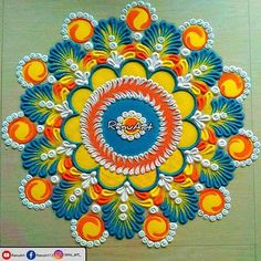 an intricate design on the floor is made with colored threads and acrylic paint