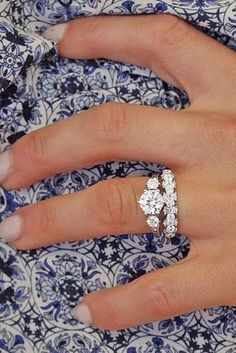 a woman's hand with a diamond ring on it